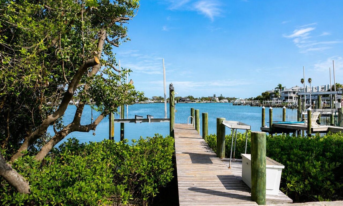 Indian Rocks Beach House | Rare last-minute DISCOUNT in Indian Rocks Beach! Renovated 3BR WATERFRONT single family home with private dock sleeps 8, WALK to the sugar-white sand beach, Includes paddle board, beach chairs, wagon & umbrellas. 3bdrm, 2 bthrm, sleeps up to 8.