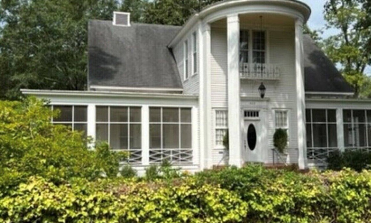 Magnolia House | Relax sitting on wrap around porch in this Historic Mansion