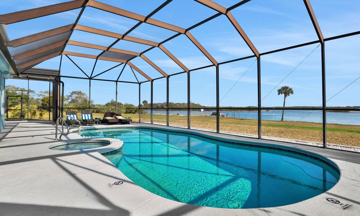 Waterway Park House | Sprawling intercoastal home with boat lifts, pool and hot tub
