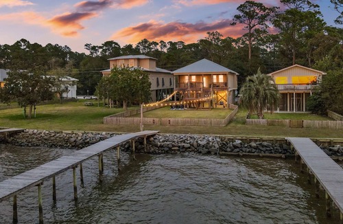 Alabama Gulf Coast House | A charming waterfront getaway on Mobile Bay featuring a private pier, cozy outdoor spaces, and beautiful bay views.