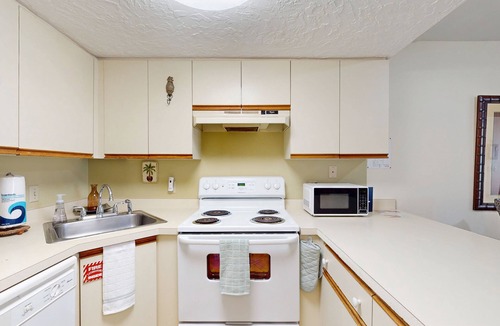 Cape Caneveral Beach Gardens Condo | Bright corner condo with shared pool, beach access, free WiFi & washer/dryer