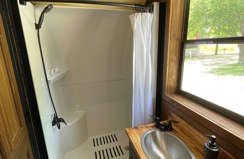 Branson Cottage | California Trail Wagon includes 1 king bed, bathroom w/shower, heat & a/c, smart tv, wi-fi, microwa