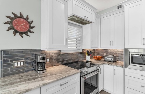Goodland Condo | Elegant Coastal Townhouse with Panoramic Water Views