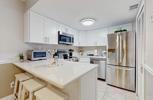 Cape Caneveral Beach Gardens Condo | Ground Floor Condo with Shared Heated Pool, High-Speed WiFi, and Central AC!