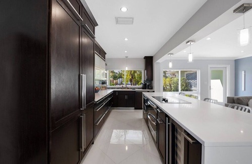 Poinsettia Heights House | Just 10min to downtown Ft. Lauderdale & beach, this modern home offers everything a group could want for an upscale relaxing getaway. Unwind in the very private and peaceful backyard oasis, featuring a heated pool ($), 6-person hot tub & fire pit.