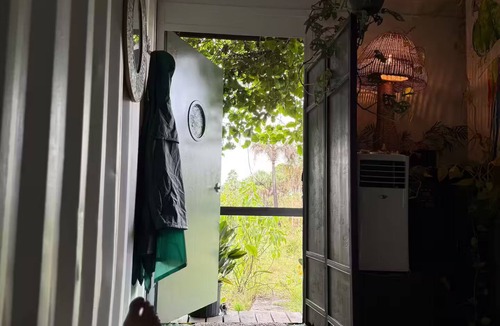 Rural Estates Cabin | Luxury off-grid passionfruit covered shipping container immersed in nature.
