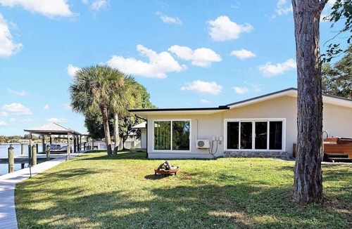 Cocoa Isles House | Luxury Waterfront Retreat Bikes, Hot Tub, Kayak, Walk to downtown Cocoa Beach.