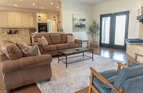 Westminster House | Modern country comfort in this 4-bedroom Anna retreat near McKinney. Sleeps 12 with open layout, full kitchen, foosball, and covered patio with BBQ. Rustic Texas charm with modern amenities — perfect for family or group getaways.