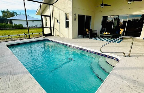 Rotonda Lakes House | Modern luxury Beach house w/free heated pool seating in half acre lot and canal