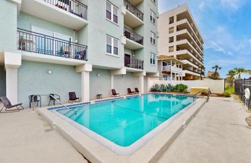 Jacksonville Beach House | Modern oceanfront condo with outdoor pool, balcony, & washer/dryer