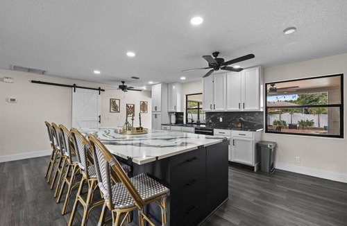 Lake Clarke Shores House | Palm Blanc- Modern Retreat Pool Firepit