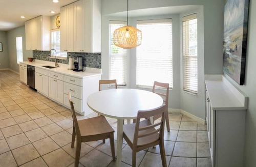 Butler Beach House | Paradise by the River - Relax in Style Near the Beach! Pool and Heated Spa