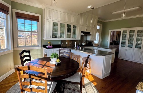 Magnolia House | Relax sitting on wrap around porch in this Historic Mansion