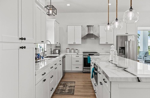 Coury House | Sunshine Getaway in Kcb Luxury Pool Home, 3BR · 3BA · Heated Pool · Bikes · Foosball · Outdoor TV · Pet-Friendly