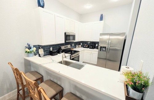Bahama Bay Condo | Top-floor 3BR/2BA penthouse at Bahama Bay Resort with peaceful waterfront pond views, private balcony, full kitchen, and separate tub & shower in both baths. Gated resort with pools & hot tubs just 15–20 mins from Disney. Sleeps 8.