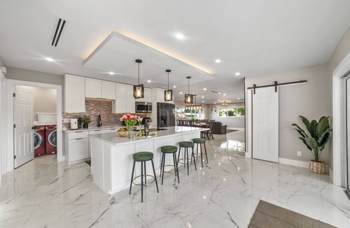 West Palm Beach Villa | Tropical Luxe Oasis with warm Pool,5 bedr 3 bath& Mini Golf, Impact Windows