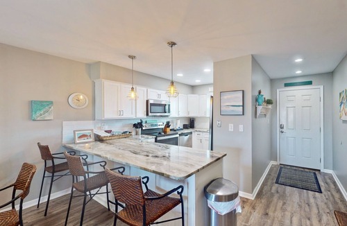 Orange Beach East Condo | Updated condo with Gulf & river views & pool - across from beach & near dining