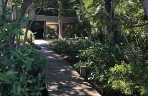 Palm Island Condo | Waterfront 2BR beach & lagoon retreat. Dock, pool, dog-friendly. Incommunicado!