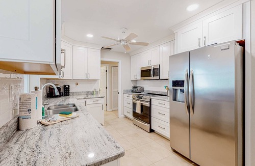 Gulf Cove House | Waterfront home with an enclosed pool, outdoor kitchen, and grill - dog-friendly