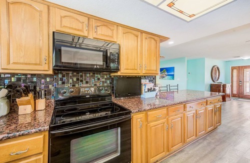 Apollo Beach House | Waterfront Oasis w/screened Lanai & Heated Pool, Private Dock + Kayaks 3BR/2BA