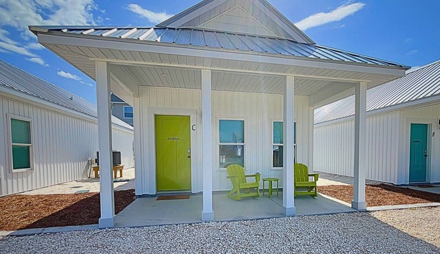 "Dolphin Cottage" is a pet friendly, 2 bed, 1 1/2 bath unit accepting 5 guests. Community Pool.