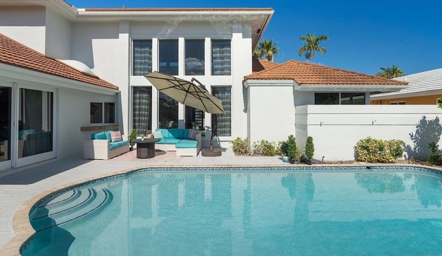 Elegant waterfront home with dock, heated pool and in a central location.