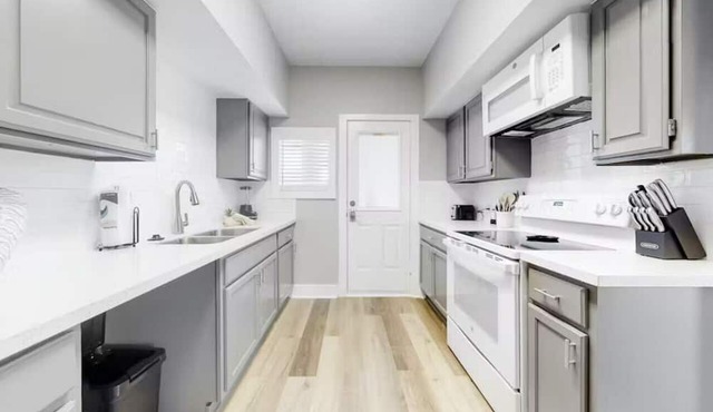 Centrally located unit with shared courtyard, designated hot tub, & fire pit!